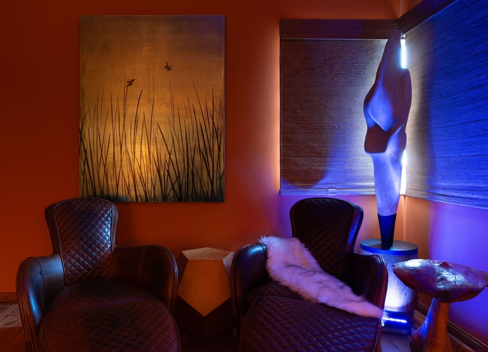 A soulful lounge nook where warm hues and sculptural details meet, offering a calming retreat for reading or relaxation.