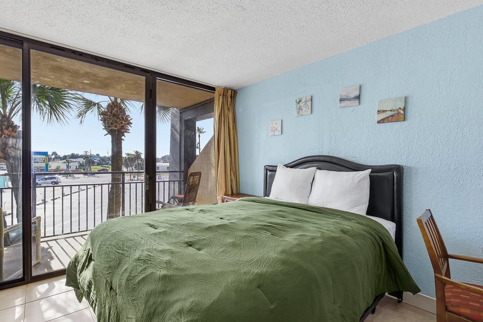 Wake up to palm views in this bright beach stay studio featuring a plush queen bed and private balcony. Just steps from the sand, enjoy coastal comfort and ocean breezes for the perfect seaside getaway. 🌴🌊
