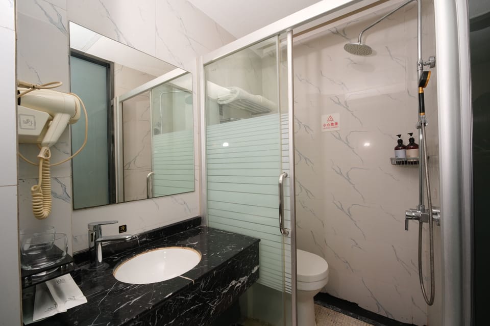 Signature Double Room, No Windows | Bathroom | Shower, hair dryer, slippers, towels