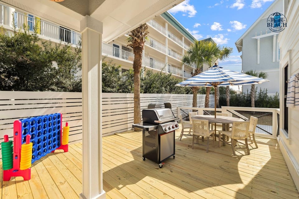 Outdoor oasis includes back yard games, gas grill and outdoor dining area.