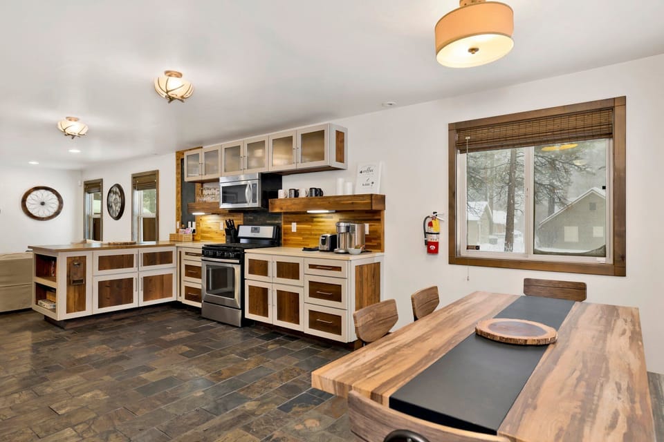 Fully equipped cabin kitchen with ample cabinetry, stove, fridge, microwave, perfect for feeling right at home on your stay.