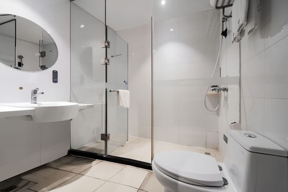 Standard Double Room | Bathroom | Shower, hair dryer, slippers, towels