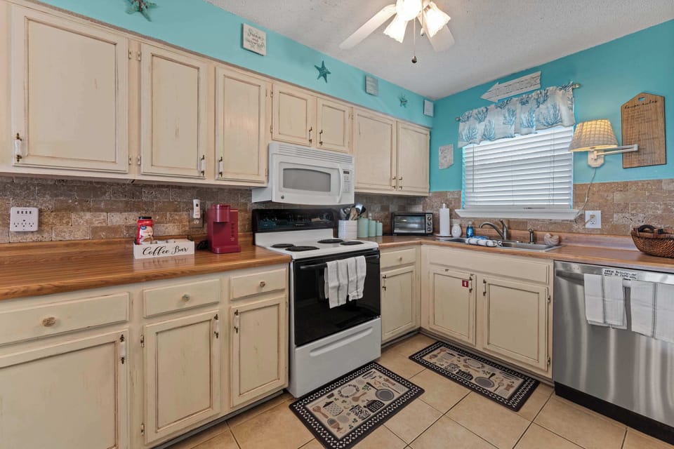 Kitchen and breakfast bar with coastal style and seating for the group.