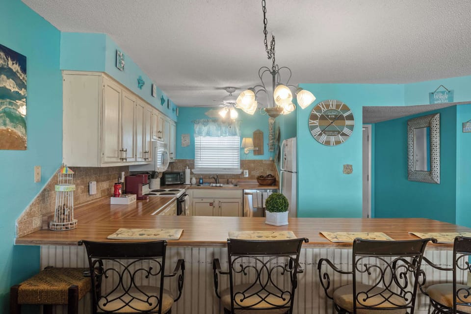 Fully equipped kitchen with full size appliances, cookware, and plenty of counter space for vacation meals.