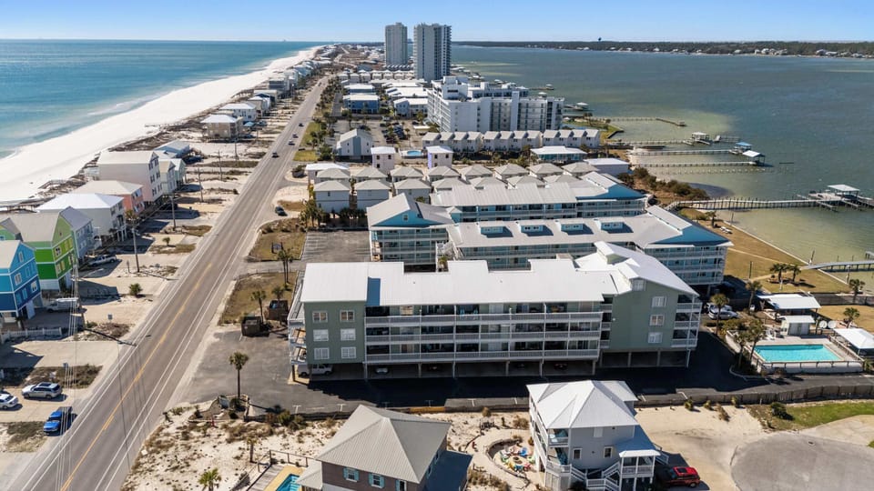 Drone view of Lagoon Landing and the surrounding Gulf Shores area, showing the condo location and nearby water access.