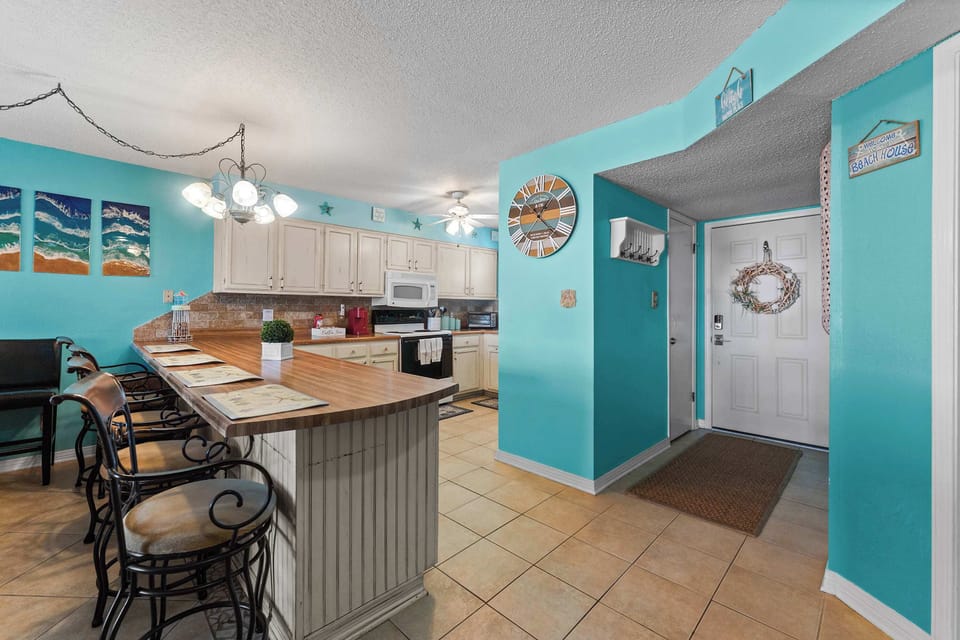 Large breakfast bar with plenty of seating, perfect for family meals, snacks, and planning your Gulf Shores adventures.