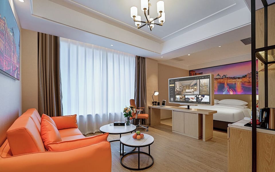 Panoramic Suite, City View | Living area | 55-inch LED TV with cable channels