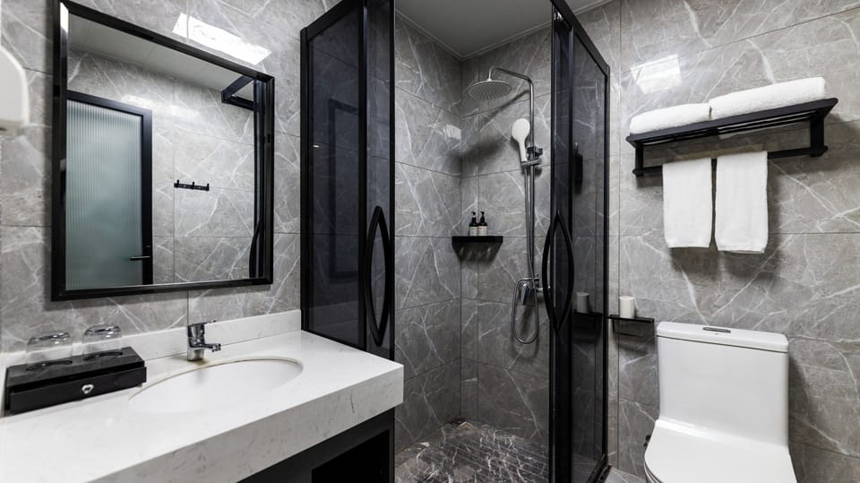 Shower, hair dryer, slippers, towels