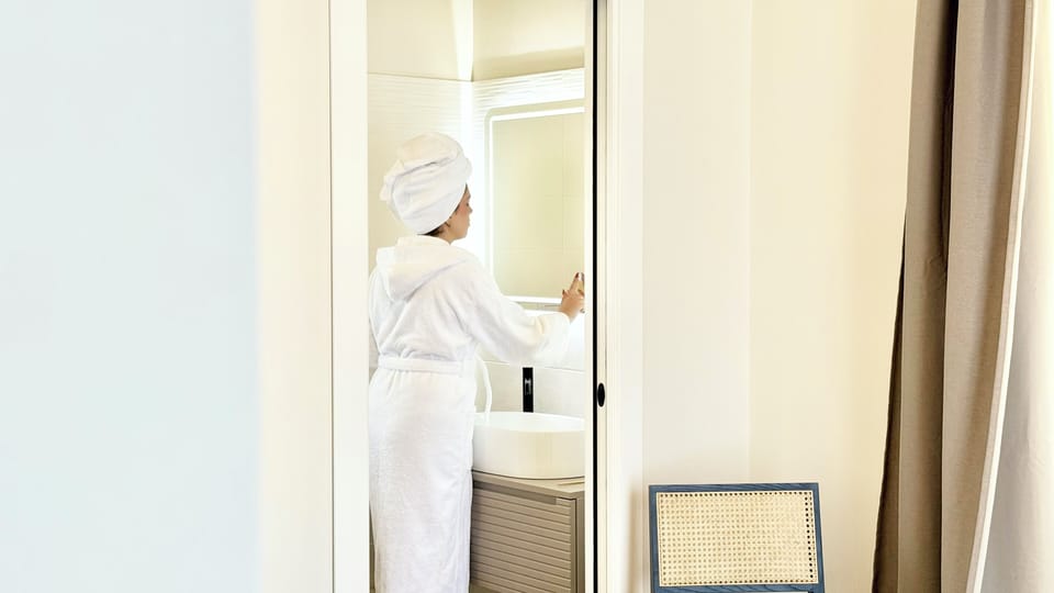 Luxury Studio Suite, 1 King Bed, City View | Bathroom | Free toiletries, hair dryer, slippers, towels