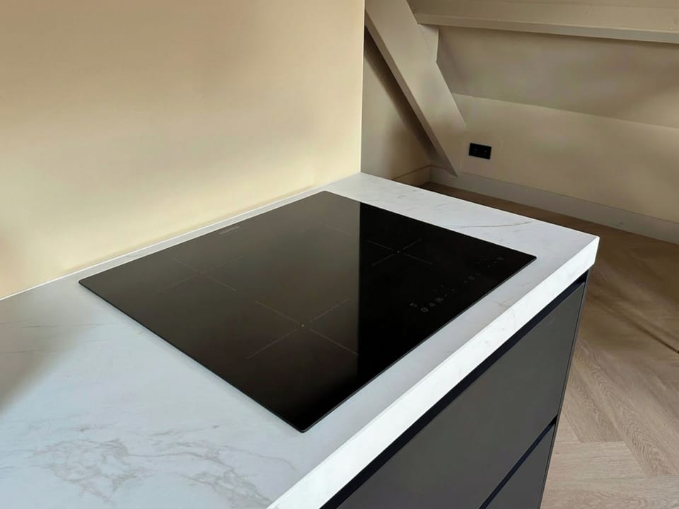 Modern induction stove for quick, safe, and energy-efficient cooking during your stay.