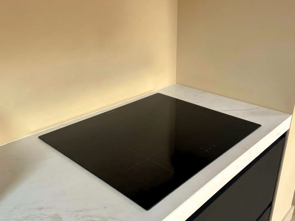 Modern induction cooktop set in a clean countertop, offering a sleek, efficient and easy-to-use cooking solution in a contemporary kitchen.