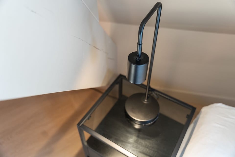 Workspace corner with desk lamp and minimalist setup.