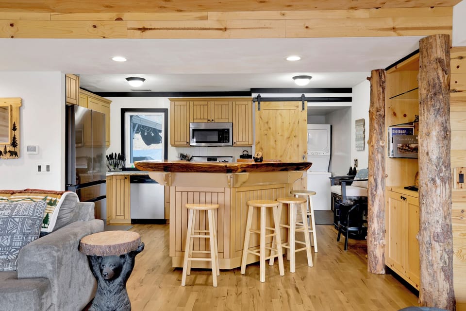Fully equipped cabin kitchen with ample cabinetry, stove, fridge, microwave, and coffee maker—perfect for cooking meals, morning coffee, and feeling right at home on your stay.