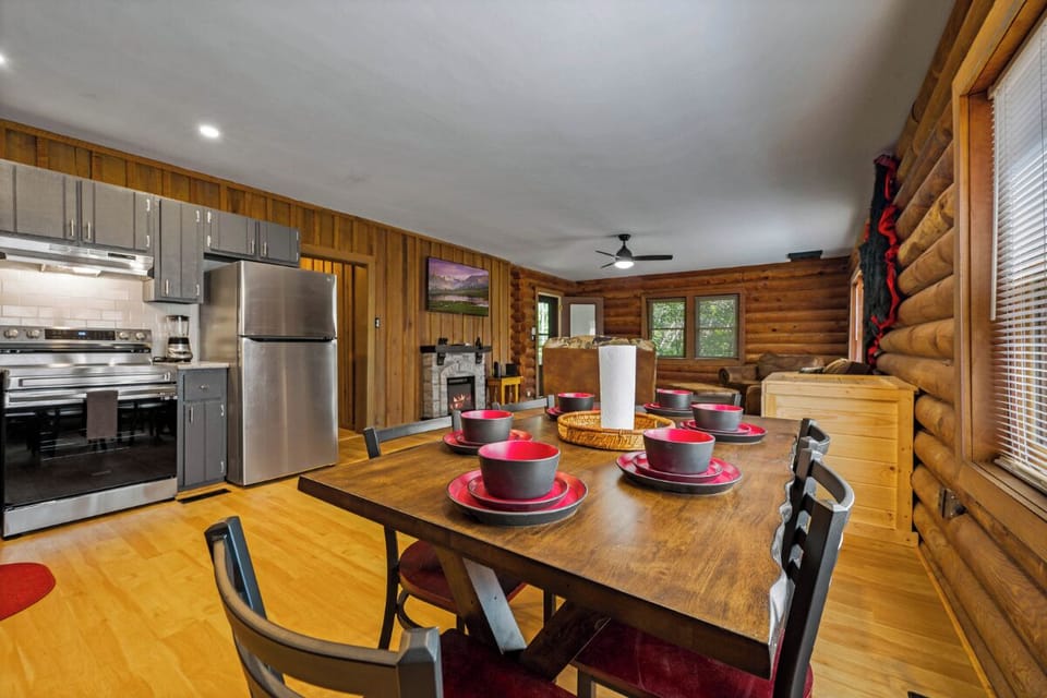 Gather around this inviting dining table in your rustic log cabin, where warm wood surrounds you and memories are made over home-cooked meals.