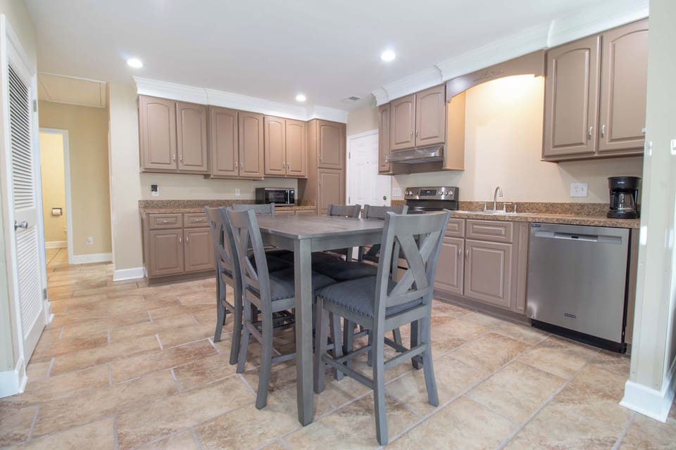 Your fully equipped kitchen awaits with modern appliances, granite counters, and a cozy dining table for memorable meals together.
