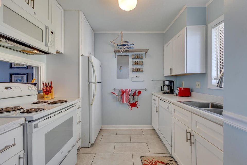 Your fully equipped galley kitchen features modern appliances, charming nautical touches, and everything you need for memorable meals.