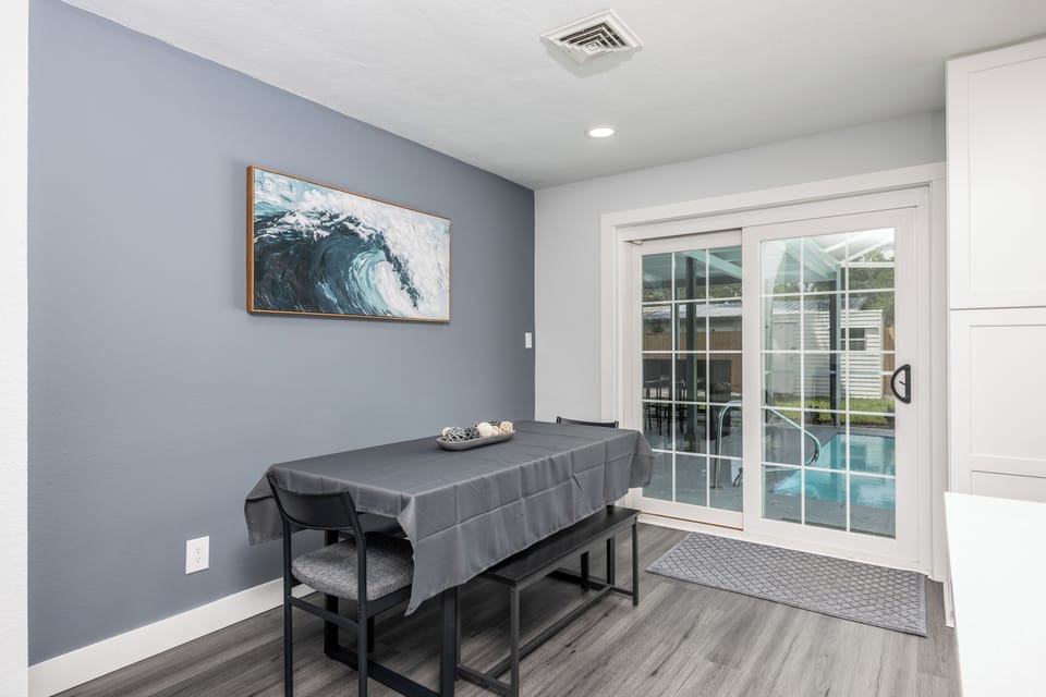 Relax at your private treatment table while enjoying serene poolside views through floor-to-ceiling windows in this peaceful wellness space.