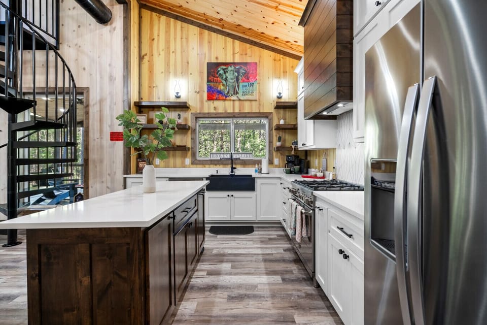 Kitchen | Spacious Island | Sleek Countertops & Vibrant Artwork
