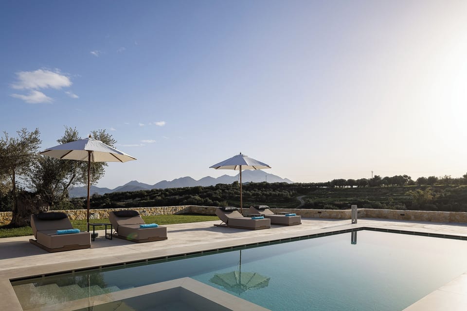 Luxury sun lounges with umbrellas to relax and rejuvenate by the pool 