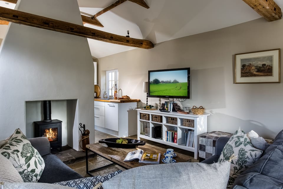 The spacious sitting room enjoys a cosy wood burning stove