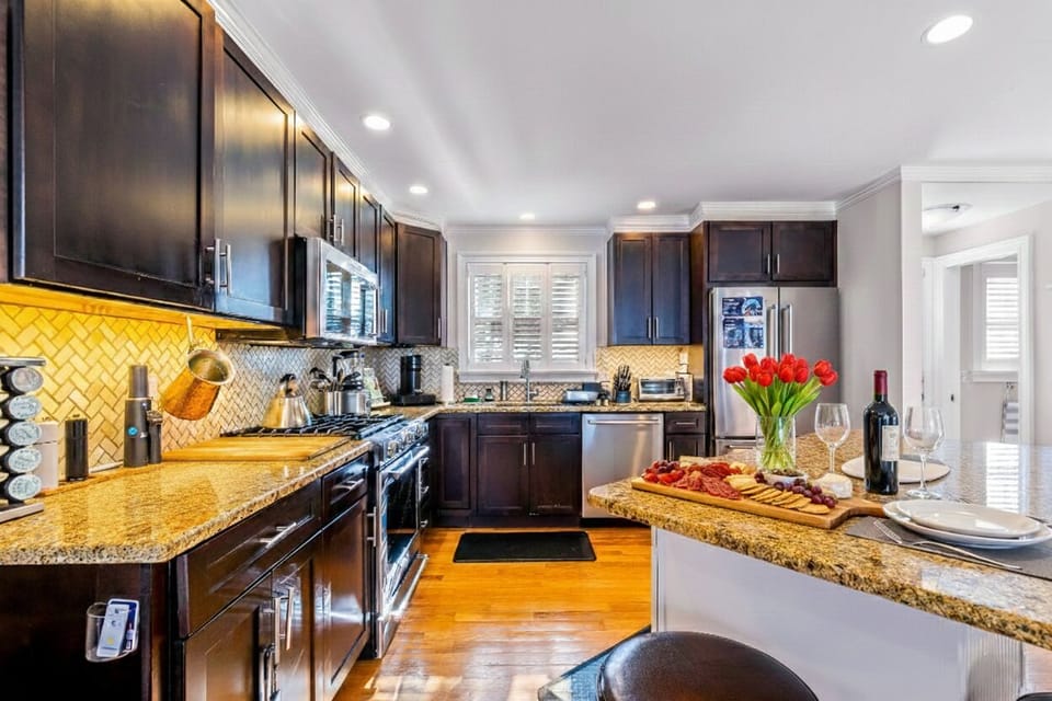 Spacious, fully stocked kitchen with sleek appliances, generous counter space, and all the essentials for cooking. A bright, inviting space where preparing meals and gathering with family or friends is a joy.