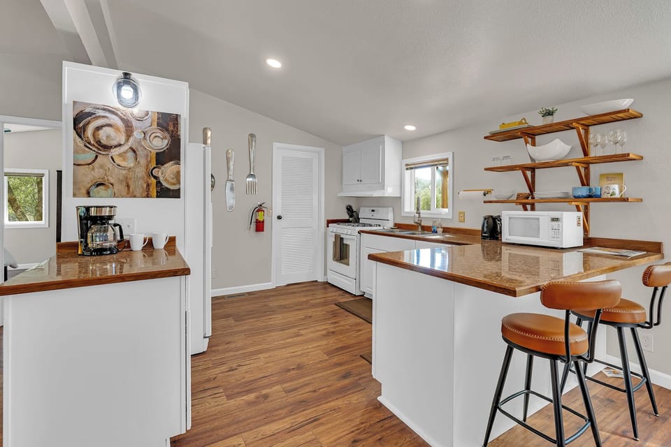 Your fully equipped kitchen, with breakfast bar seating, so you can stay-in and cook satisfying meals.