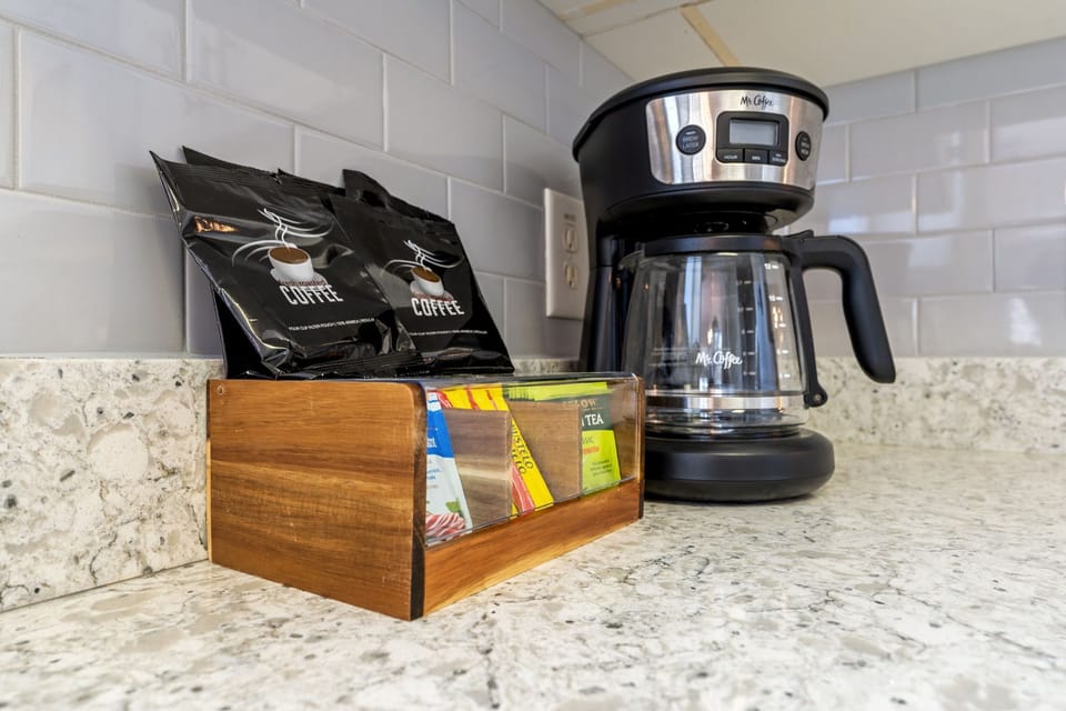 Wake up to a stocked coffee & tea bar with drip brewer and supplies.