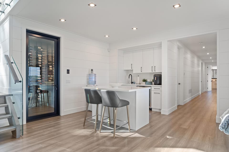 Bright, modern kitchen with sleek island and wine fridge