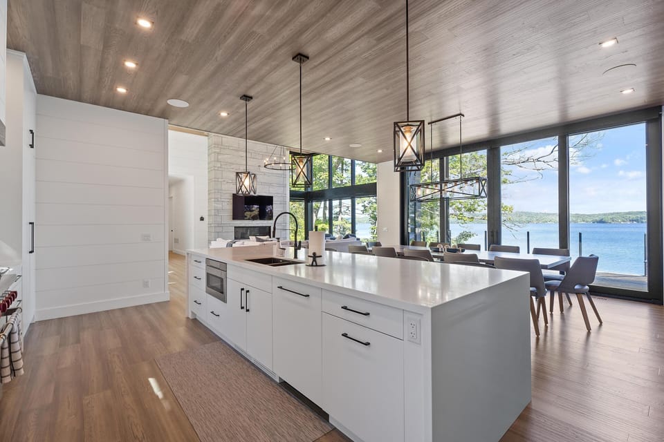 Sleek modern kitchen with panoramic lake views and natural light