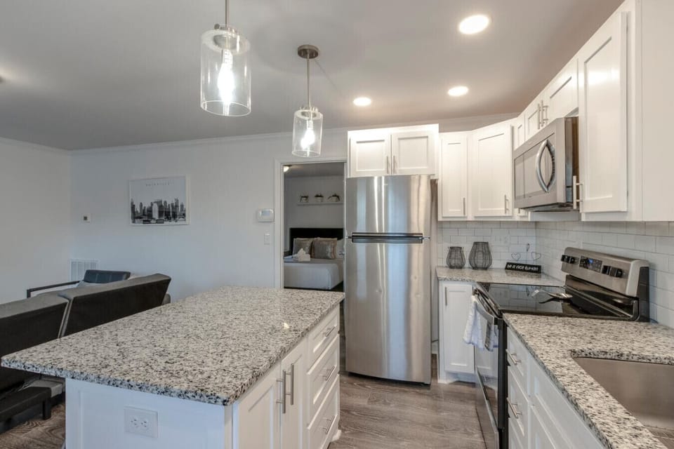 Kitchen close-up of the granite island countertop and stainless steel refrigerator