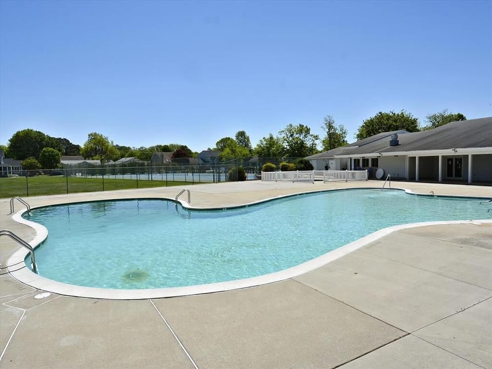 Dive into relaxation at the community pool (accessible for a fee), surrounded by serene greenery and offering a perfect retreat for family fun and leisure.