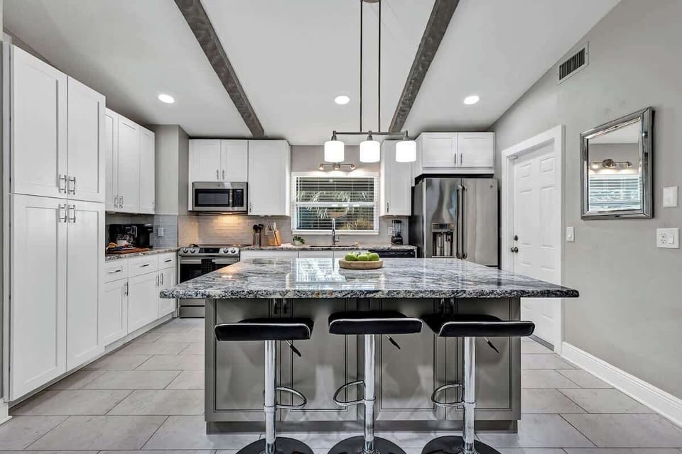Spacious and elegant full kitchen! Large french door refrigerator, pots, pans, silverware, cooking utensils, blender, air fryer, insta pot, drip coffee machine, Keurig coffee machine, 3 comfortable bar stools around spacious island.