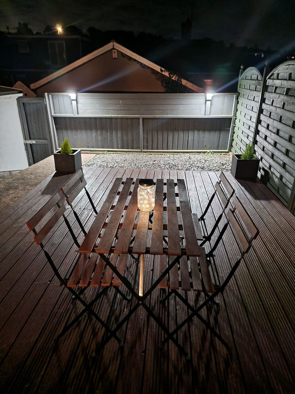 Outdoor bistro table and chairs on the garden decking