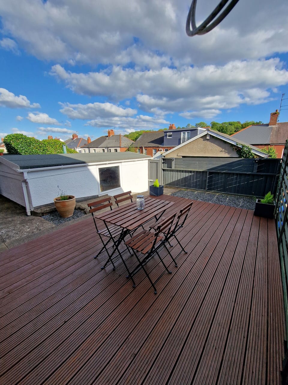 Private rear garden with wooden deck and outdoor seating