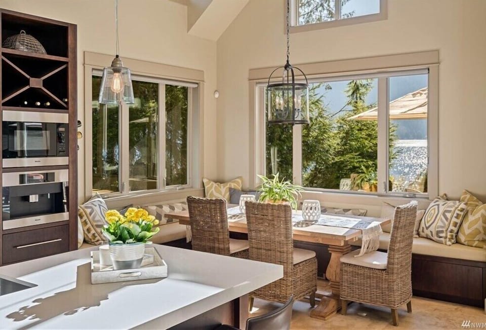 Dining area with ample seating, open to the living room and kitchen, featuring breathtaking views throughout.