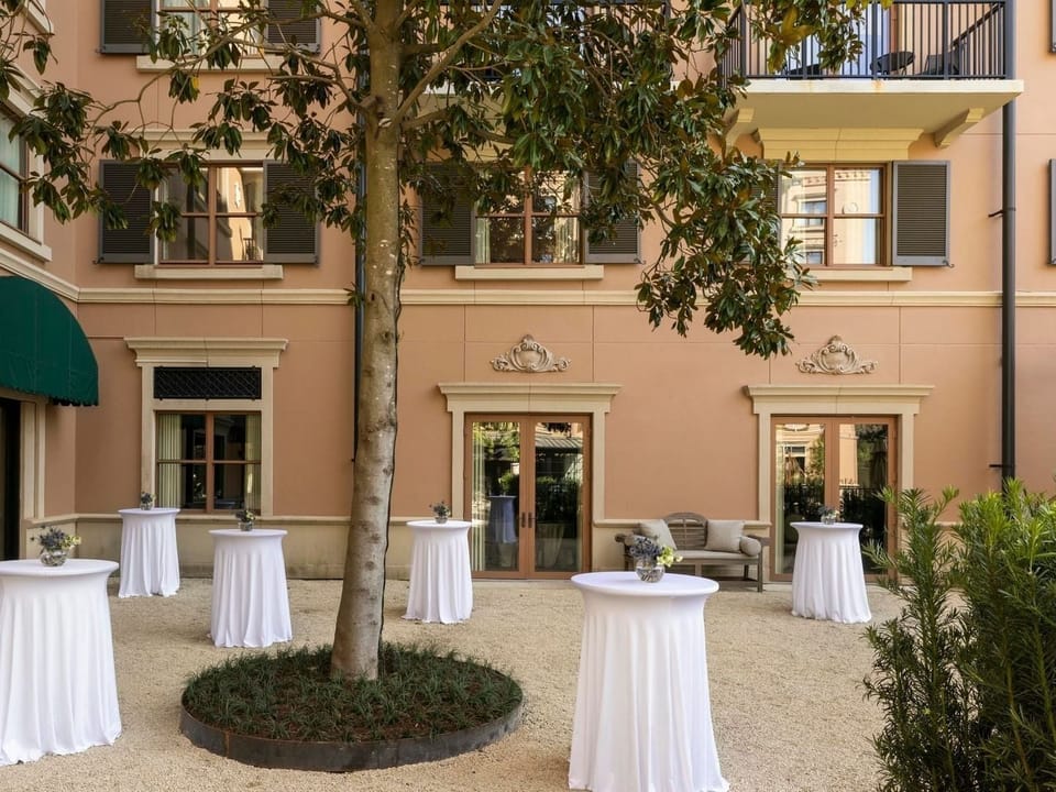 Toast the evening in a charming courtyard with intimate tables.