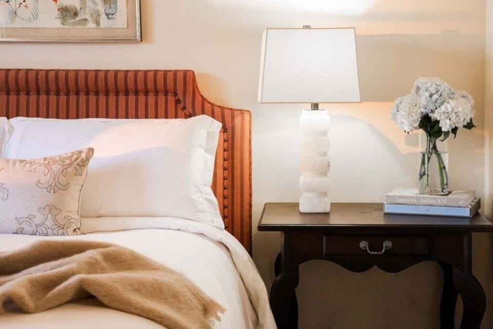 Savor thoughtful bedside details with warm, calming lighting.