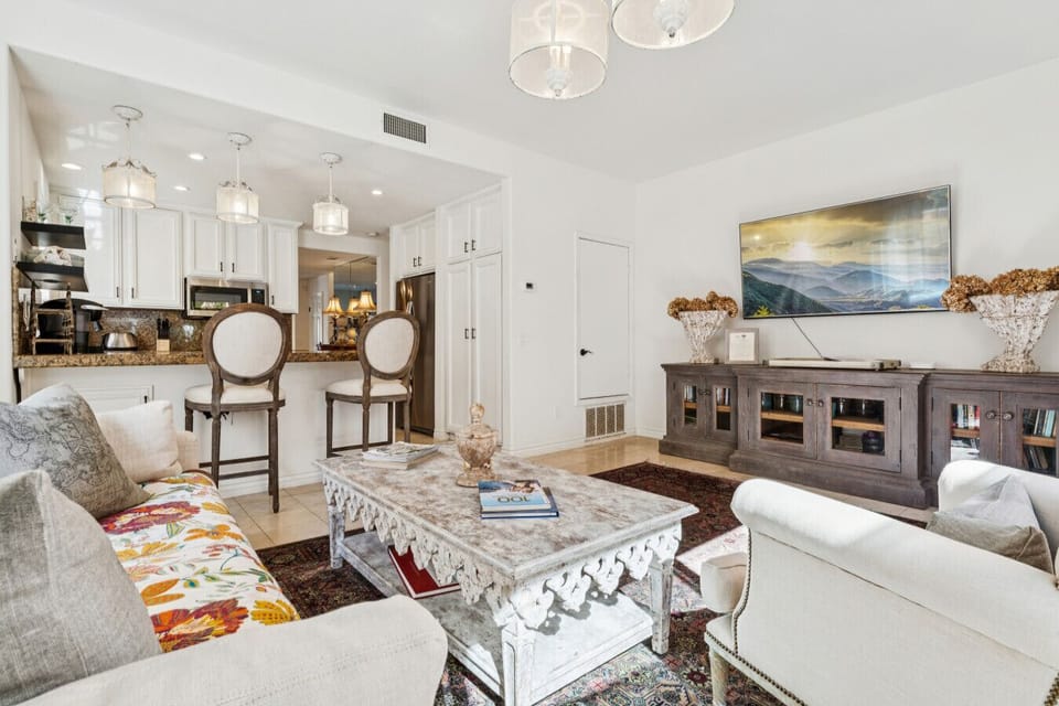 Bright open living room with designer furnishings and seamless flow to the kitchen.