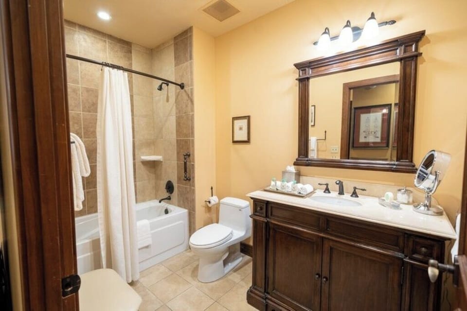 Freshen up in a spacious bath with bright vanity lighting.