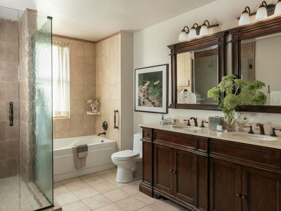 Refresh in a spacious bath with soaking tub and glass shower.