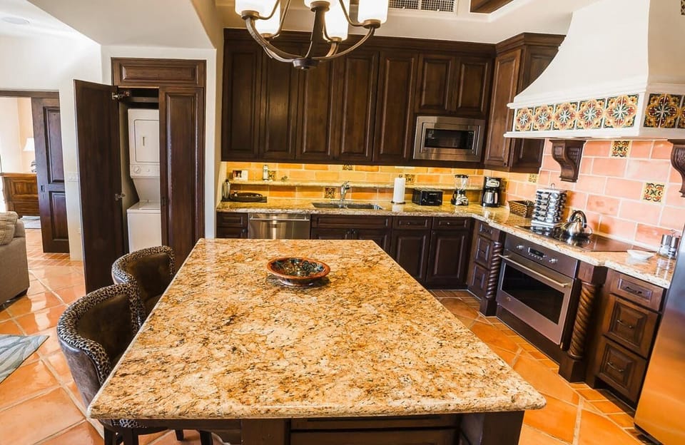 Cook effortlessly on granite counters with full chef-style kitchen.