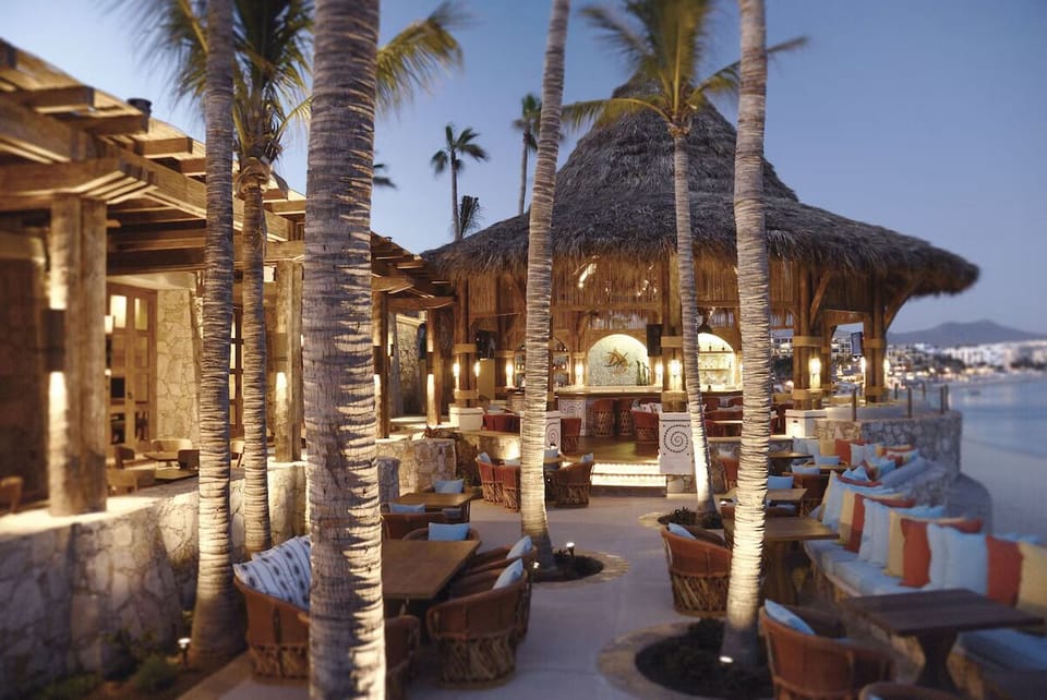 Unwind with cocktails and ocean breezes under glowing lights