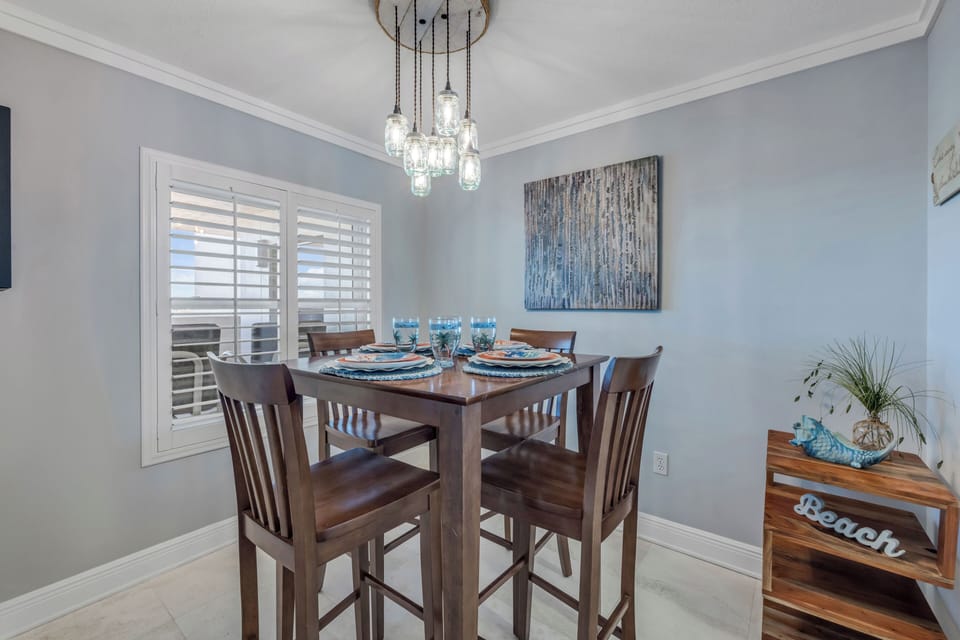 The dining room offers seating for four, with bonus barstool seating at the kitchen counter for additional guests