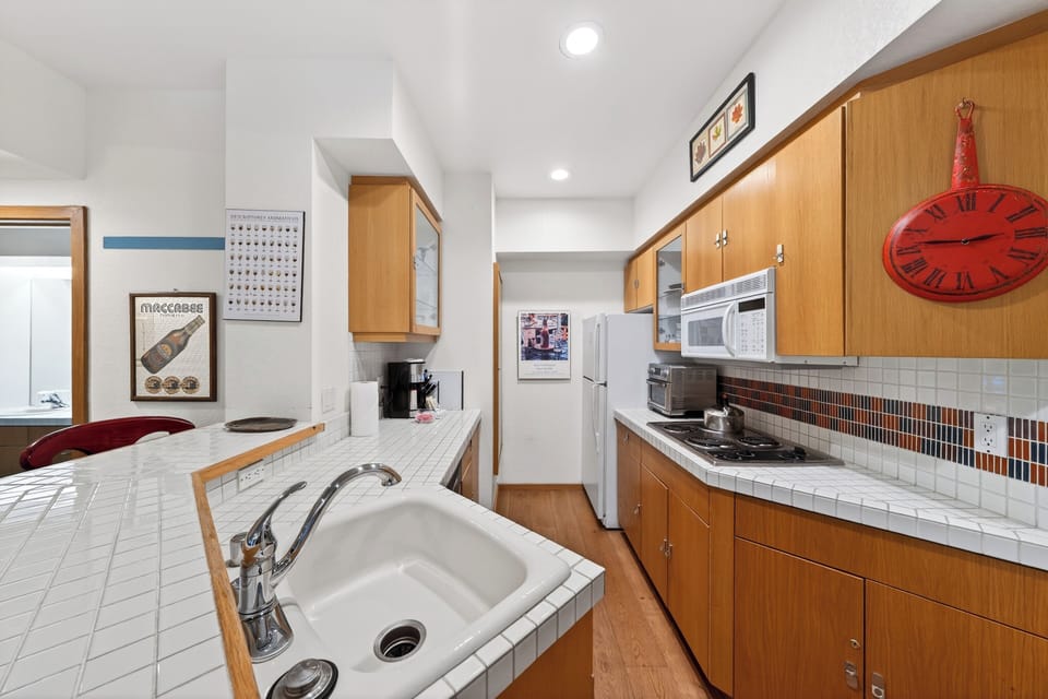 Cozy kitchen with breakfast bar seating — fully equipped for easy mornings, quick bites, and après-adventure meals.