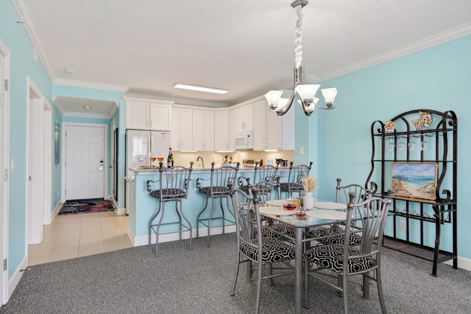 Bright coastal dining nook—gather for meals, games, and happy hour before heading back out to the balcony views.