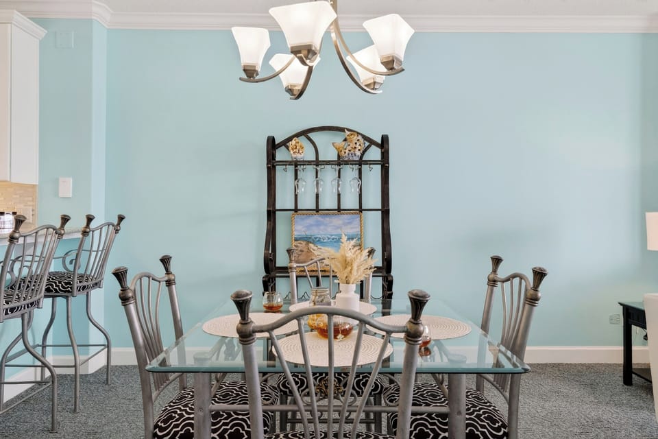 Bright coastal dining nook—gather for meals, games, and happy hour before heading back out to the balcony views.