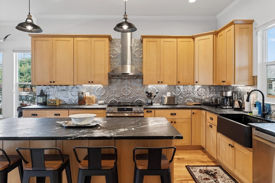 Spacious chef’s kitchen with a huge island, bar seating, and stainless steel appliances—perfect for group meals.