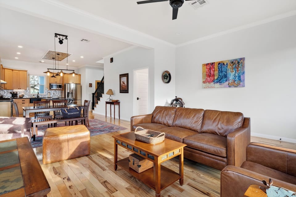 Bright, open living space with comfy seating—flowing right into the kitchen and dining area.