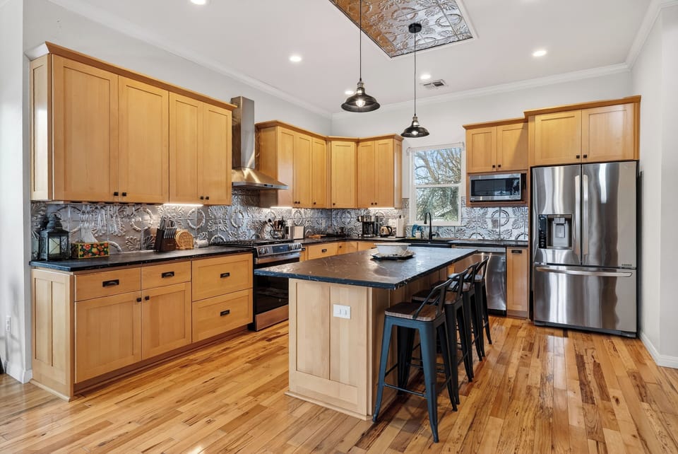 Chef-ready kitchen with a large island, stainless steel appliances, and plenty of seating for the whole group.