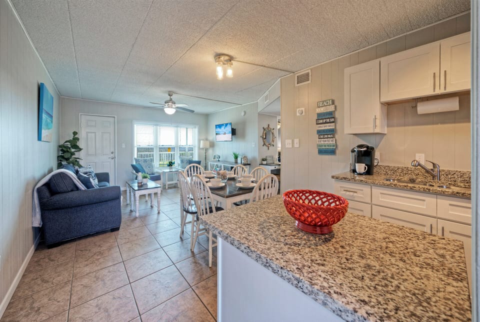 Bright, open layout connecting the kitchen, dining, and living areas—perfect for easy mornings, shared meals, and relaxed evenings after a day at the beach.